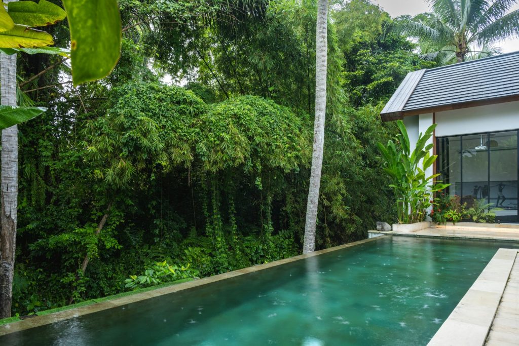 A house with a pool in front of it