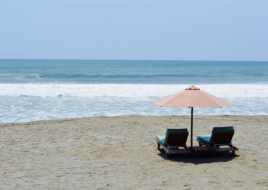 Beach umbrella and loungers on the sand