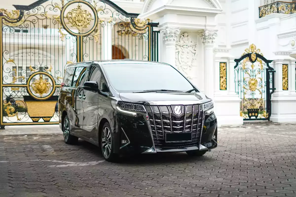 Black Toyota Alphard parked at a private estate entrance