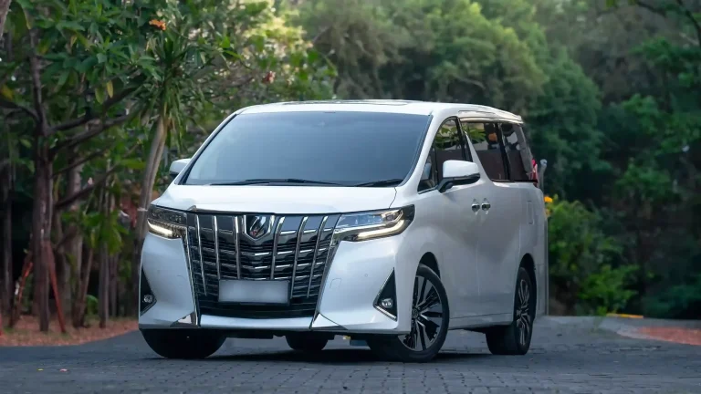 White Toyota Alphard chauffeur car on a jungle road in Bali