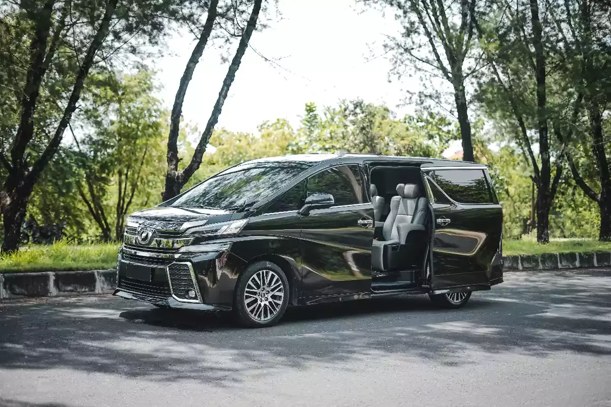 Toyota Vellfire with sliding door open under the trees
