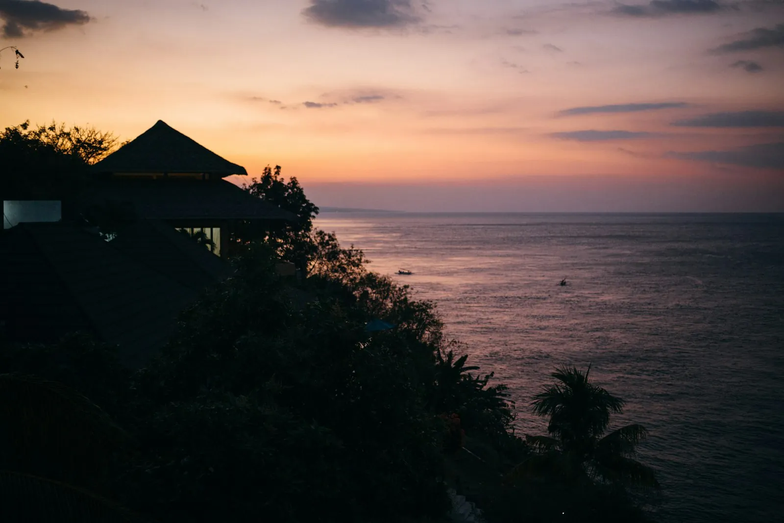 Clifftop pavilion silhouetted at sunset