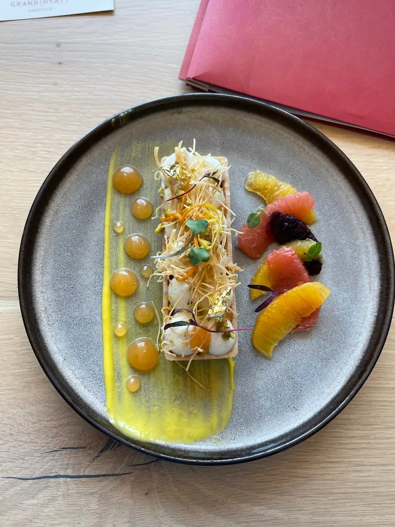 Fine dining plate with citrus and edible flowers