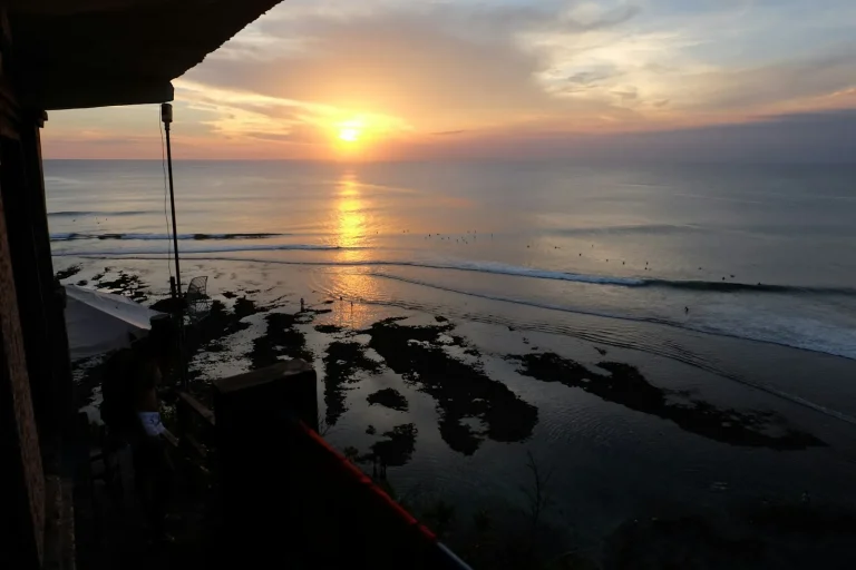 Sunset over the ocean from a clifftop terrace