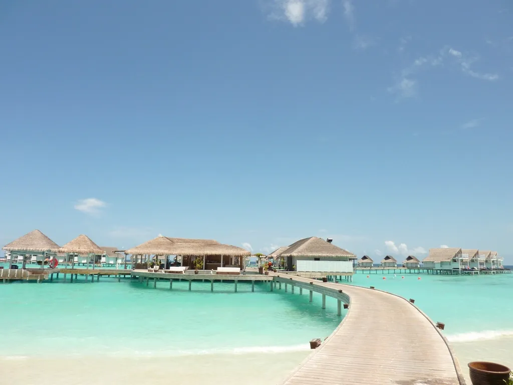 Overwater villas above a turquoise lagoon