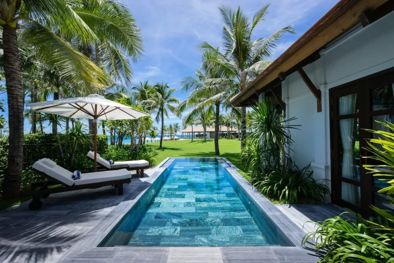 Long lap pool in a palm garden villa