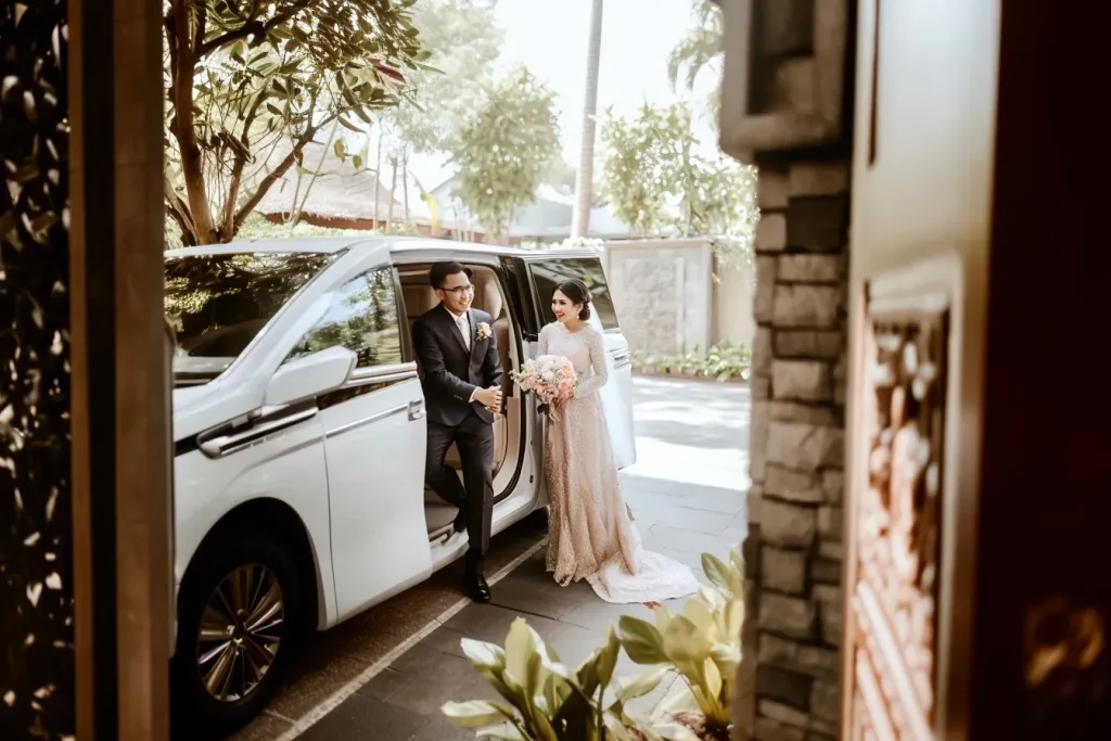 Wedding couple stepping out of a chauffeured Alphard in Bali
