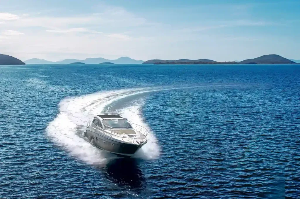 Private motor yacht cruising at speed in open water